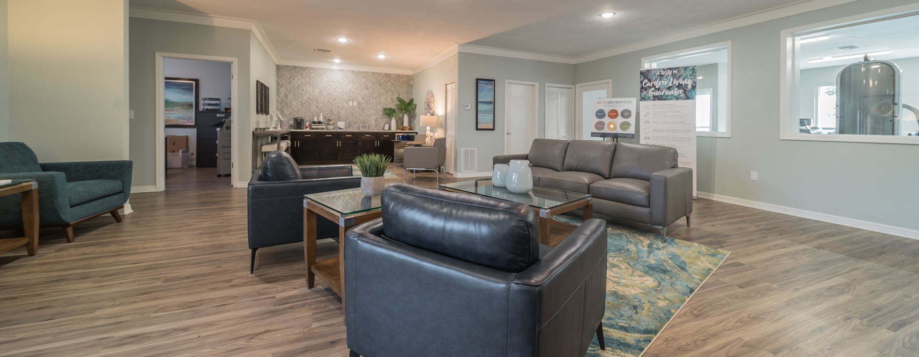 a clubroom with couches, tables and chairs