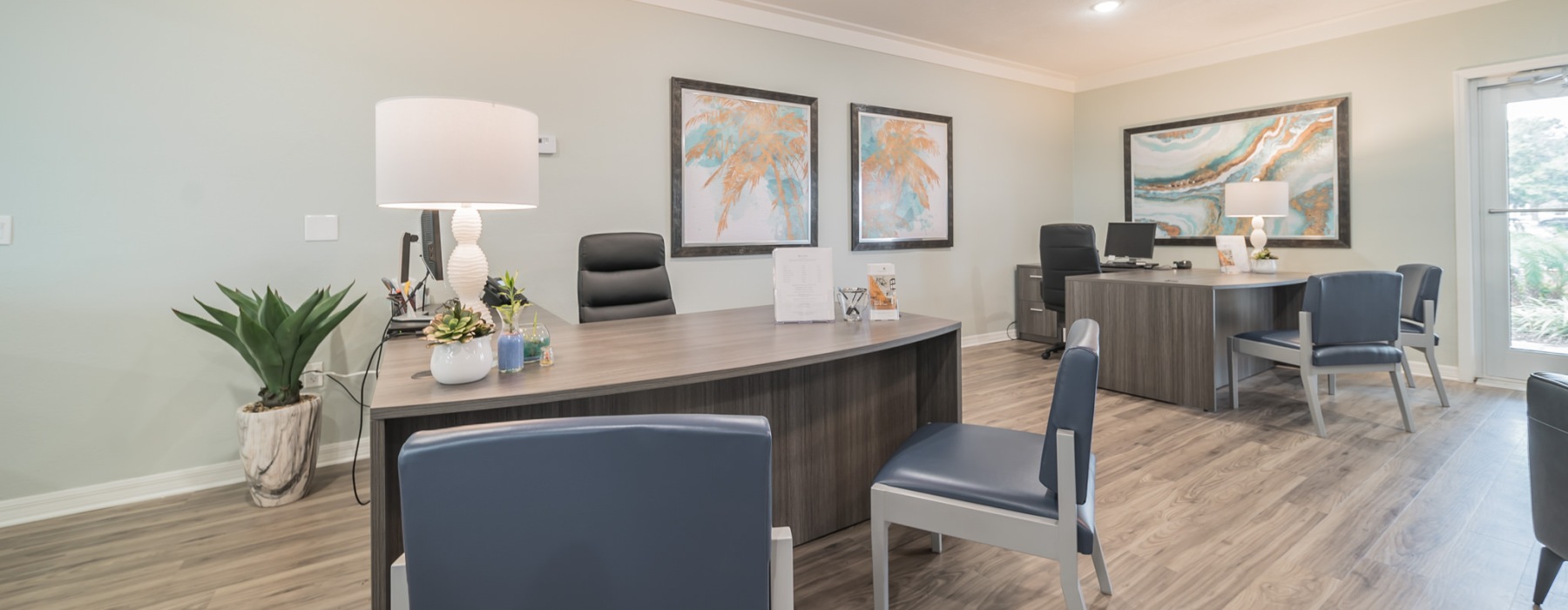 a leasing office with desks and chairs