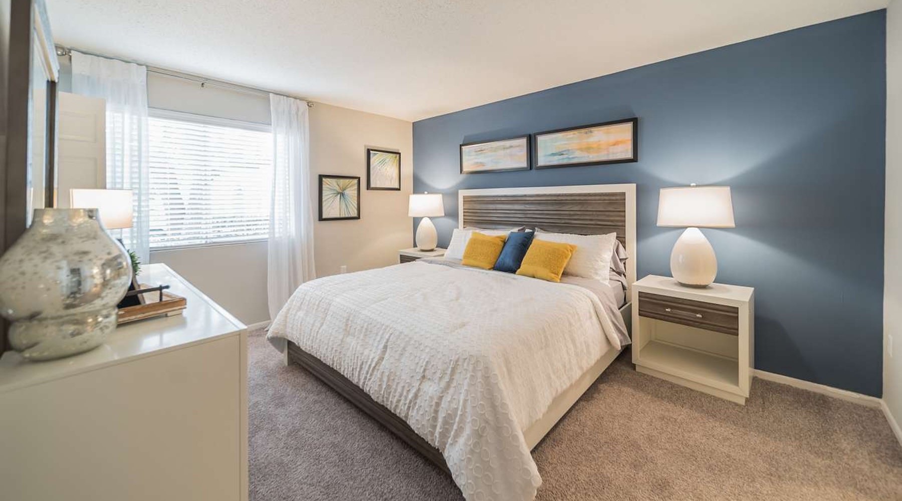 a bedroom with a bed and two nightstands