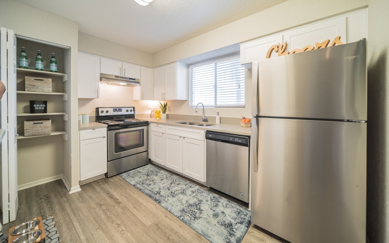 a kitchen with white cabinets
