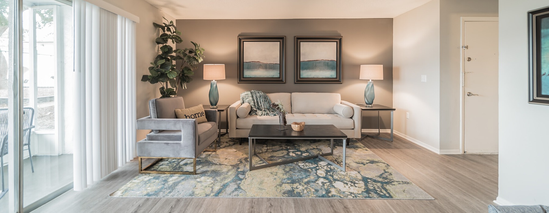 a living room with a couch, table and chair