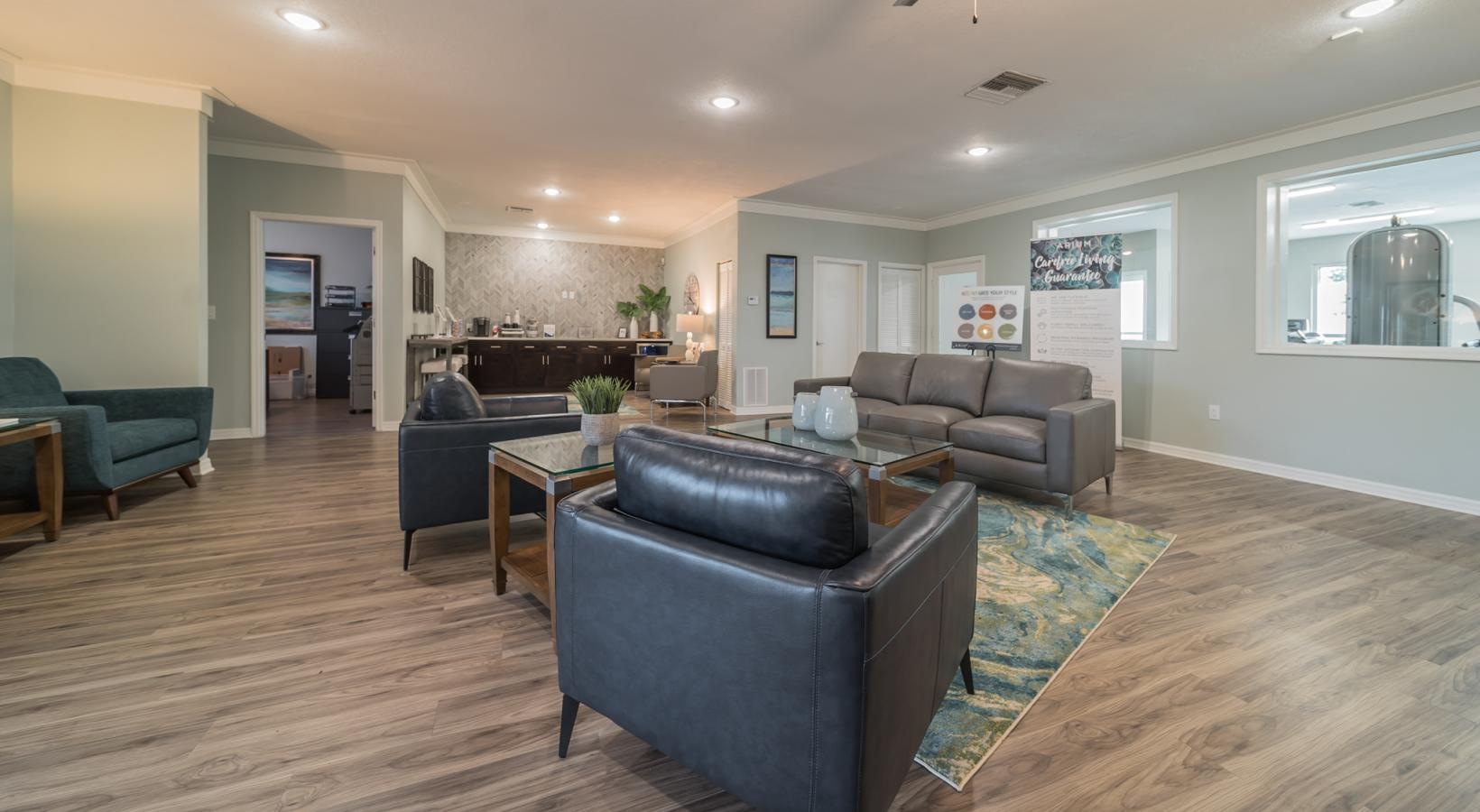 a clubroom with couches, tables and chairs